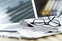 Newspaper on laptop Newspaper on laptop