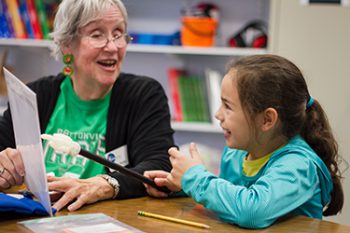 Oasis Tutor, Martha Murphy and student read togethe