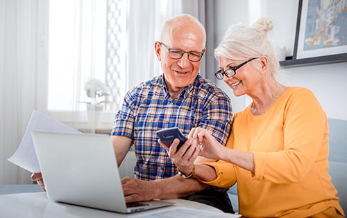 Senior couple registering online Senior couple registering online