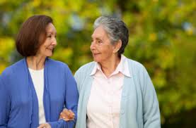 Two ladies going for a walk arm in arm