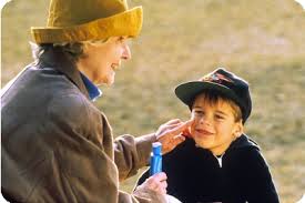 Woman applying sunscreen to a child