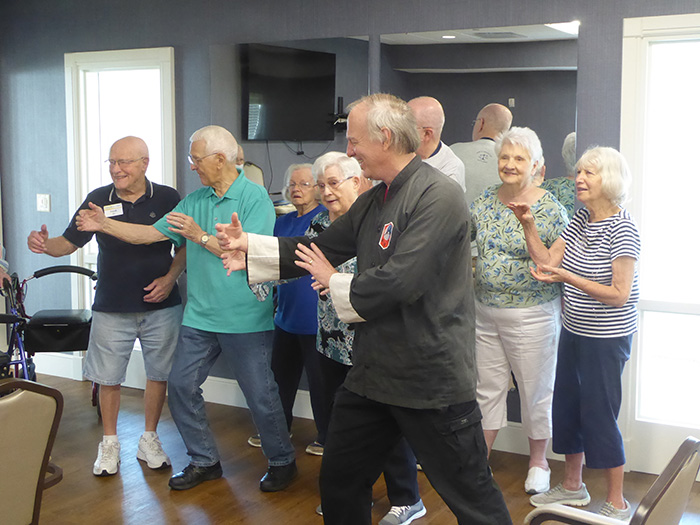 Margaret Olds “We have fun and move!” says Margaret Olds of the Tai Chi classes led by longtime Oasis instructor George Gajdos at her senior community. Margaret is the third person from left.