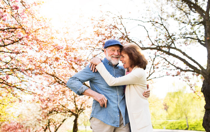 Beautiful senior couple in love outside in spring nature.